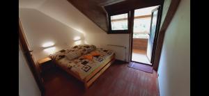 niewielka sypialnia z łóżkiem i oknem w obiekcie Chata Kriváň - bez kontaktu s ubytovateľom "Click 'n Sleep" w Tierchowej