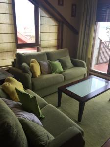 a living room with a couch and a coffee table at VIVIENDA CORRUBEDO VISTA DUNAS in Corrubedo