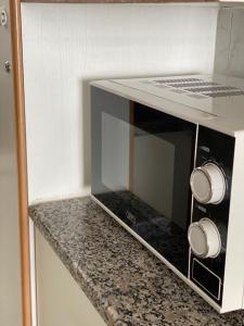 a microwave oven sitting on top of a counter at 86 windermere self catering apartments in Durban