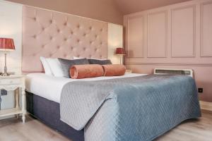 a bedroom with a large bed with a large headboard at Westport Country Lodge Hotel in Westport