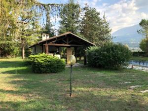 a small building in a yard with a ball in the grass at Casa Verde in Monticchio