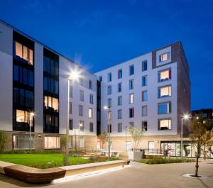 a large white building with street lights in front of it at Stylish 3 Bedroom Apartments and Private Bedrooms at Dorset Point in Dublin City Centre in Dublin