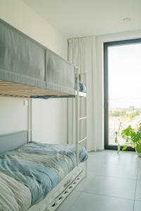 sypialnia z 2 łóżkami piętrowymi i dużym oknem w obiekcie Ostend Port Side incl parking w Ostendzie