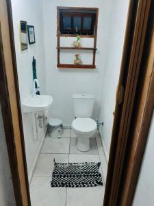a bathroom with a toilet and a sink at Chácara - Usina Atibaia in Atibaia
