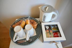 a table with a plate of food and a tea kettle at Great Location Private Entrance in Monterosso al Mare