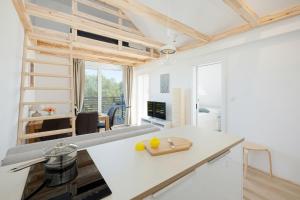 a kitchen and living room with a couch and a table at Apartamenty Południowa 14 by Noclegi Renters in Dźwirzyno