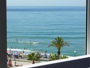 a view of a beach with people in the ocean at Madrid-M504 in Torrox Costa