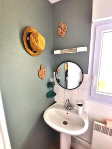 a bathroom with a sink and a mirror at Superbe vue mer... Au calme in Ault