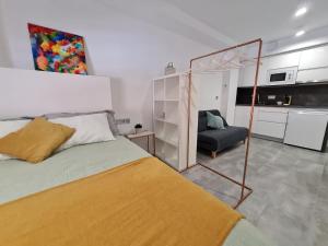 a bedroom with a bed and a chair in it at LoftinMalaga in Málaga