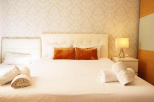 a bedroom with a white bed with towels on it at Bcn-rentals apartments in the Old town in Barcelona