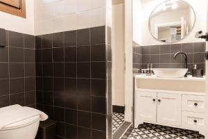 a bathroom with a toilet and a sink and a mirror at Villa La Varik 1 in Litochoro