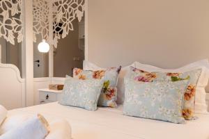 a white bed with four pillows on it at Villa La Varik 1 in Litochoro