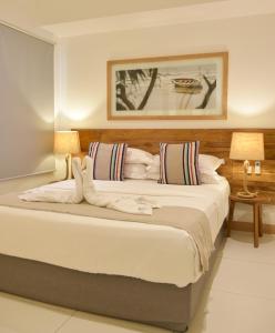 a bedroom with a large bed with two lamps at Latitude - with private plunge pool in Rivière Noire