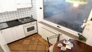 a small kitchen with a table and a window at Residenza Monti in Rome