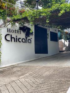 a hotel chirico sign on the side of a building at Hotel Chicala salgar in Puerto Salgar