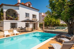 a villa with a swimming pool and a house at #049 Villa Lemon by Home Holidays in Albufeira