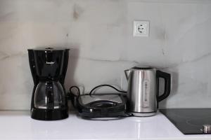 a kitchen counter with a coffee maker and a blender at LIDO APARTMENTS in Himare