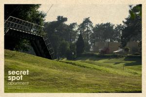 a bridge over a grassy hill in a park at Secret Spot Apartment - Quinta da Barca in Esposende