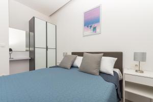 a bedroom with a blue bed with pillows at Villa Simon in Makarska +37 photos