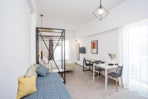 a living room with a couch and a dining room at Kappa Apartments in Faliraki