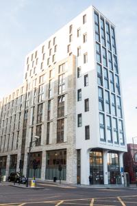 a large white building on the corner of a street at Chic Studios at Chapter Highbury II in London in London