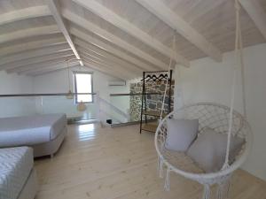 a room with a swing and a bed at Lithos Villas in Skala Eresou
