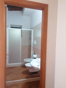 a bathroom with a toilet and a sink at La Piana Di Calena in Peschici
