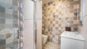 a bathroom with a toilet and a sink and a shower at Etti - Paradise Rosa Maria in Pájara +28 photos