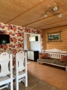 a living room with wooden walls with flowers on the wall at Вежа in Bukovel