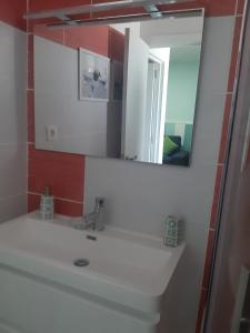 a bathroom with a white sink and a mirror at La Gomera in Gran Tarajal +20 photos