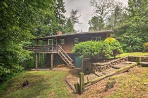 a cabin in the woods with a wooden house at Secluded Stanardsville Cabin with 10 Acres and Hot Tub in Stanardsville