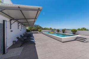 a patio with chairs and a swimming pool at Villa Simon in Makarska