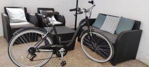 a bike parked next to a chair and a couch at CASA EL REMANSO DE ZUHEROS in Zuheros