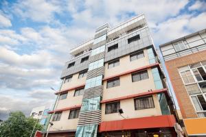 a tall building on a city street at Octave Kanthi Comforts in Bangalore