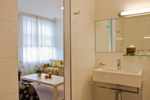a bathroom with a sink and a mirror at Art Hotell in Rakvere
