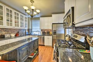 a kitchen with white cabinets and a stove at Striking Cape May Getaway, Steps From the Beach! in Cape May