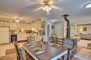 a kitchen and dining room with a table and a stove at Southeast Michigan Escape about 3 Mi to Adrian! in Adrian