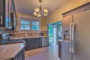 a kitchen with stainless steel appliances and gray cabinets at Cozy Birmingham Abode Less Than 7 Mi to Downtown Fun! in Birmingham
