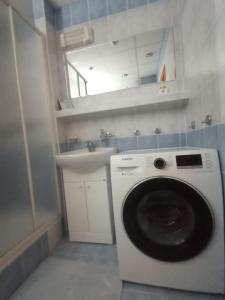 a washing machine in a bathroom with a sink at EMMA in Nová Lesná