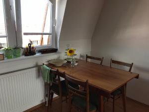 a dining room table with chairs and a sunflower on it at EMMA in Nová Lesná +30 photos