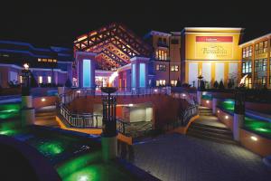 a group of buildings at night with green lights at EurothermenResort Bad Schallerbach - Hotel Paradiso Superior in Bad Schallerbach