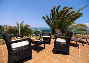a group of chairs and tables on a patio at Apartamentos Fuerteventura Sol in Costa Calma