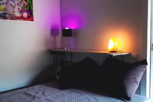 a bedroom with a bed with a table and a lamp at INSOLITE STUDIO -La Tour des Templiers- in Montfrin
