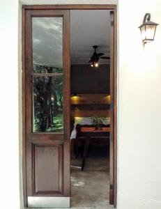 a door leading to a bedroom with a ceiling fan at Aloja Merlo in Merlo