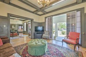 a living room with a couch and a chair at Elegant, Historical Santa Ana Home with Gardens in Santa Ana