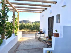 un patio en una casa con mesa y sillas en Villa AURORA Nijar, en Níjar