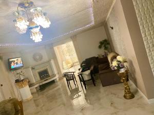 a living room with a fireplace and a chandelier at Han in Selʼtso +10 photos