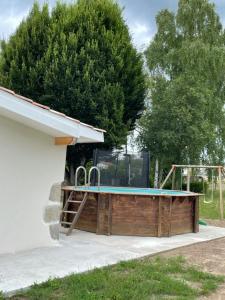 a swimming pool in a backyard with a playground at Le Cottage de Romas in Villeneuve-sur-Lot