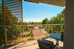 a balcony with a table and a view of a house at LAGUNA Apartament Polanica Residence 36 LUX in Polanica-Zdrój