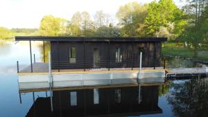 a house on a dock on a body of water at Dom na Wodzie in Kruklanki